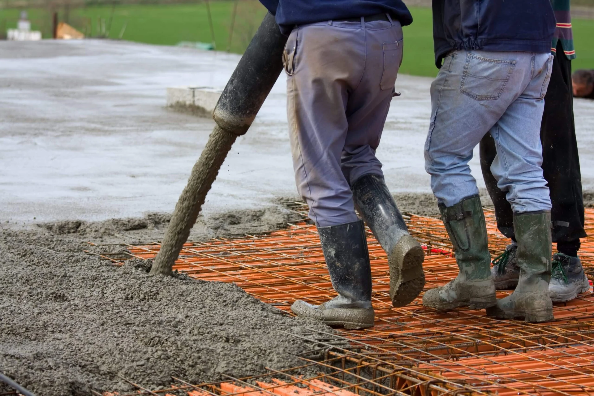 Workers pouring concrete on big floor construction on the construction site