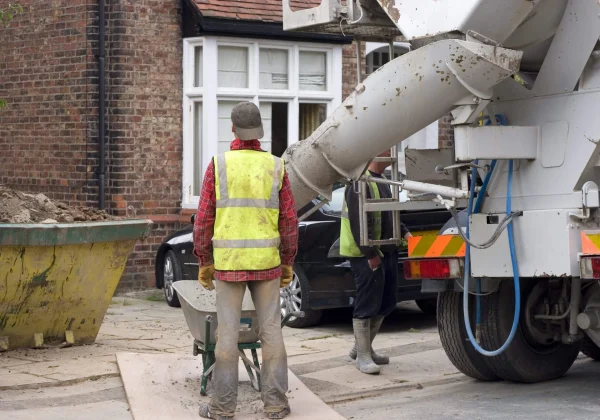 Sussex Ready Mix employees pouring concrete on a driveway